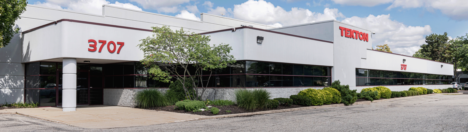 White Tekton building exterior on a sunny day. 