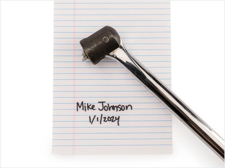 Warrantied Tekton tool on paper with name and date
