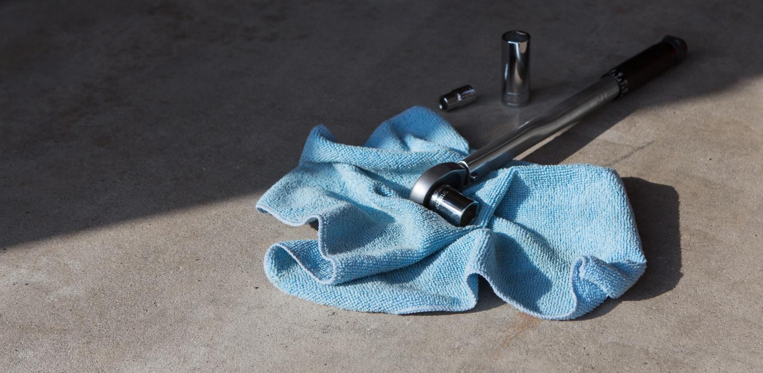 A Tekton micrometer torque wrench with a socket attached.